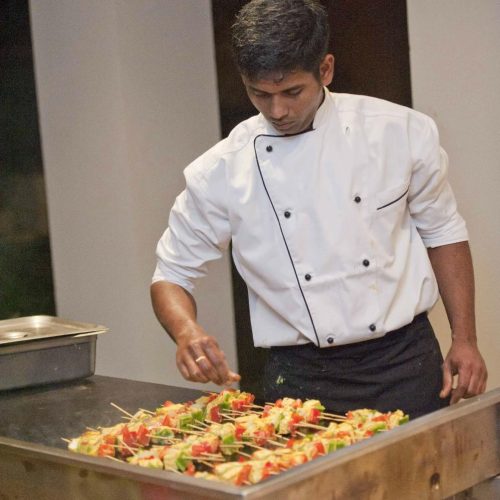 Owner of Copper Chimney preparing Chicken Tandoori, showcasing the Best Indian Food in Perth Australia, at our Indian Restaurant near me in Perth.